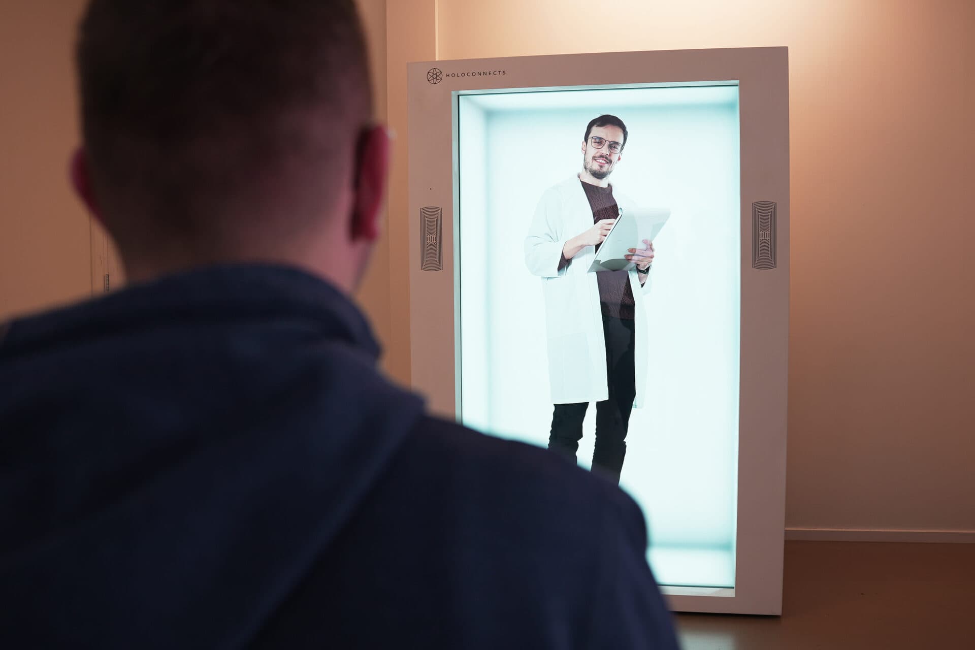 A clinician consulting with a patient via a lifesize Holobox hologram display.