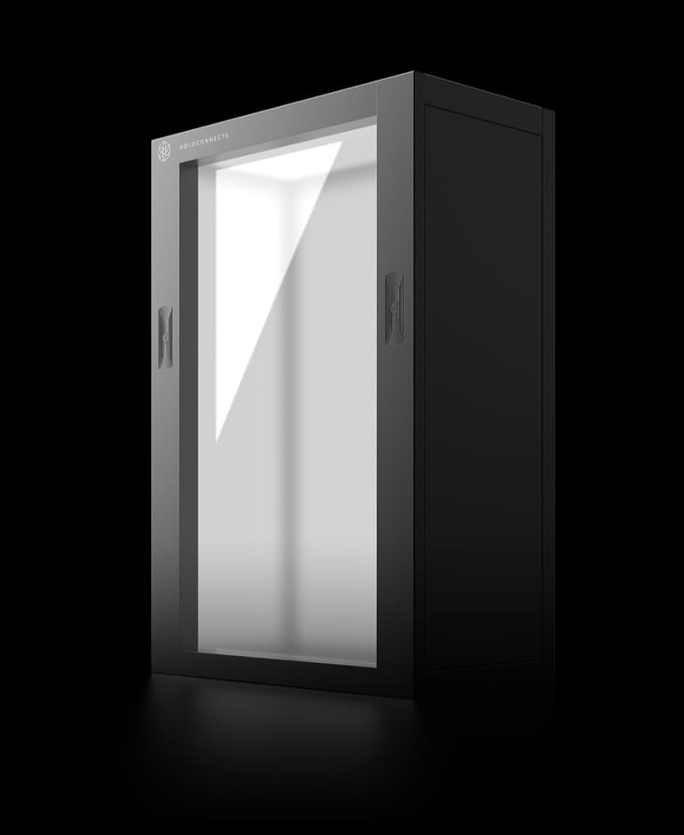 The Holoconnects Holobox, a black cabinet with a transparent display panel.