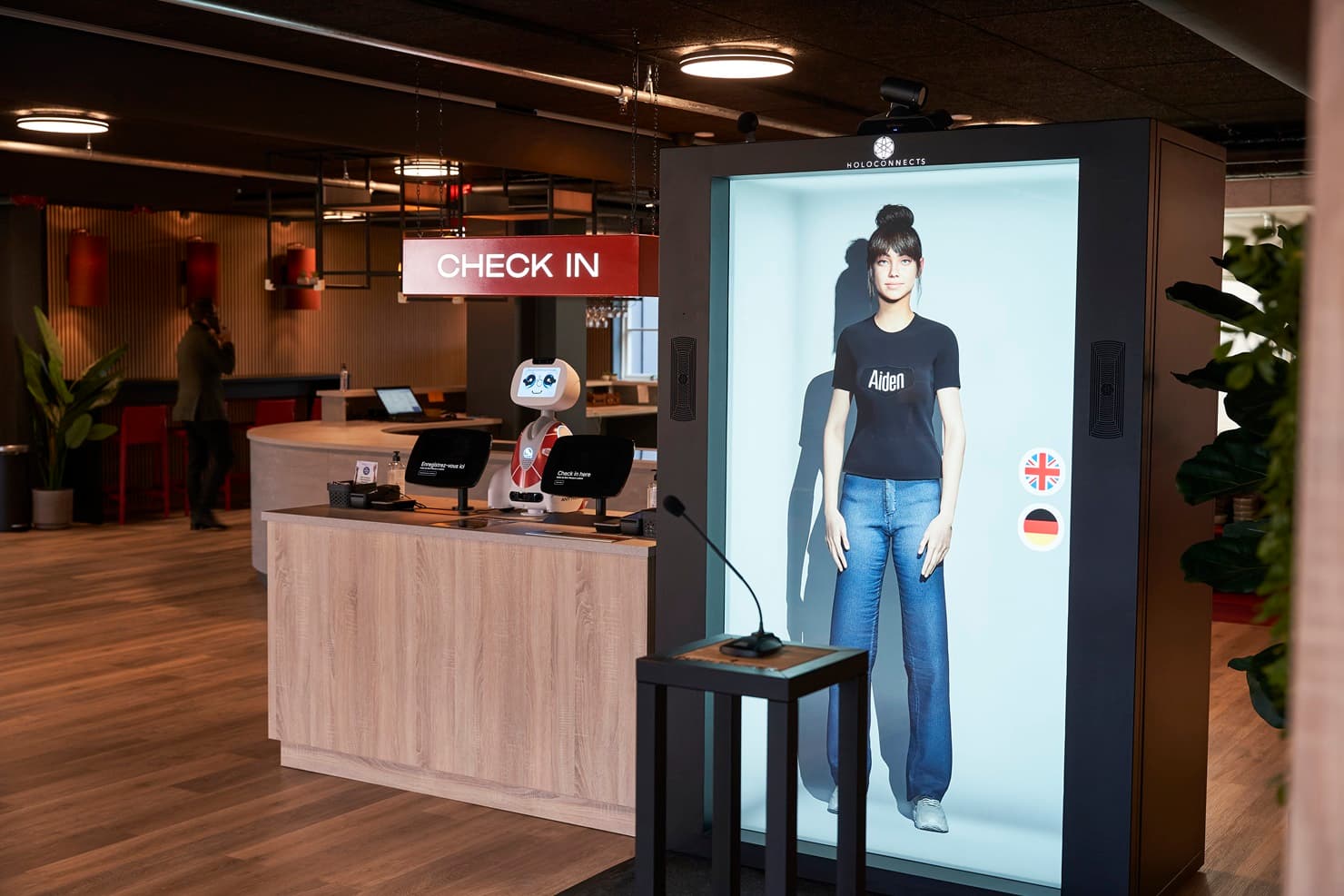 AI powered holographic check-in avatar inside a Holobox at Aiden by Best Western.
