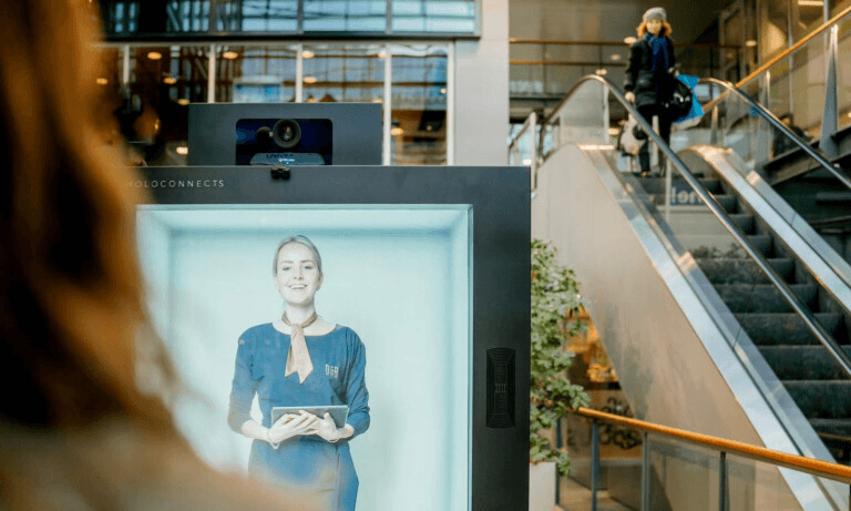 Holobox-powered hospitality welcome, a holographic concierge greeting hotel guests.